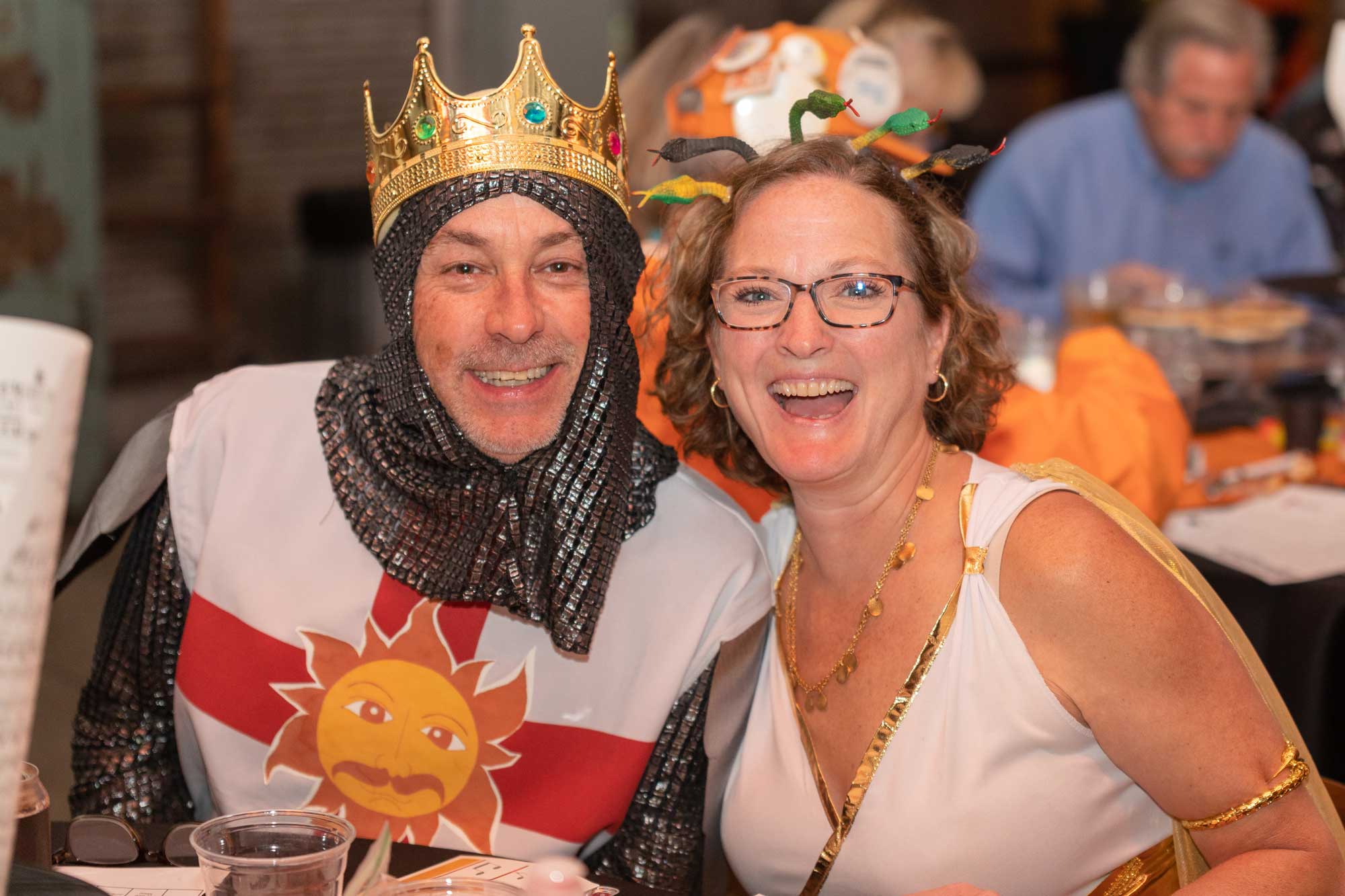 A man and woman dressed as a knight and Medusa pose for a photo.